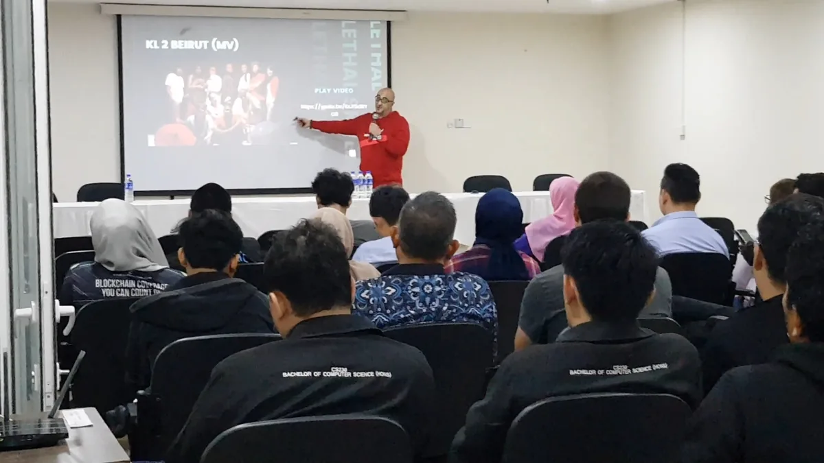 Skillz presenting to a room, the audience in front of him