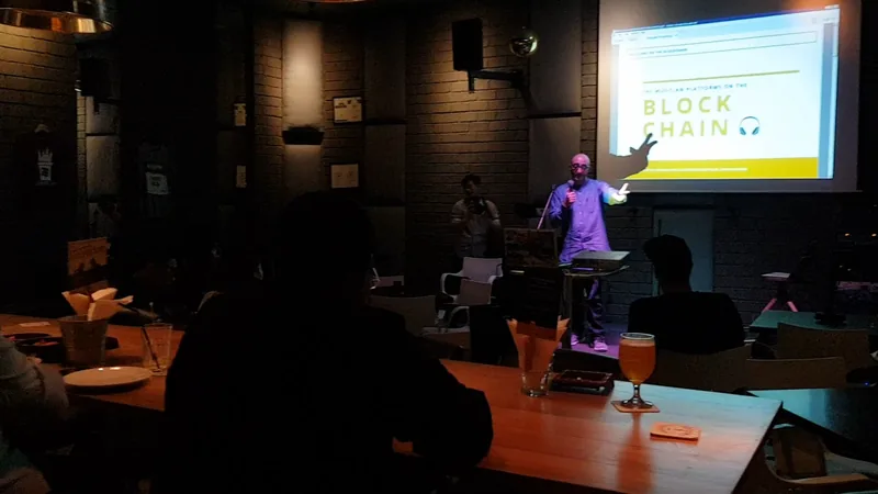 Speaking in a dark room, audience silhouettes