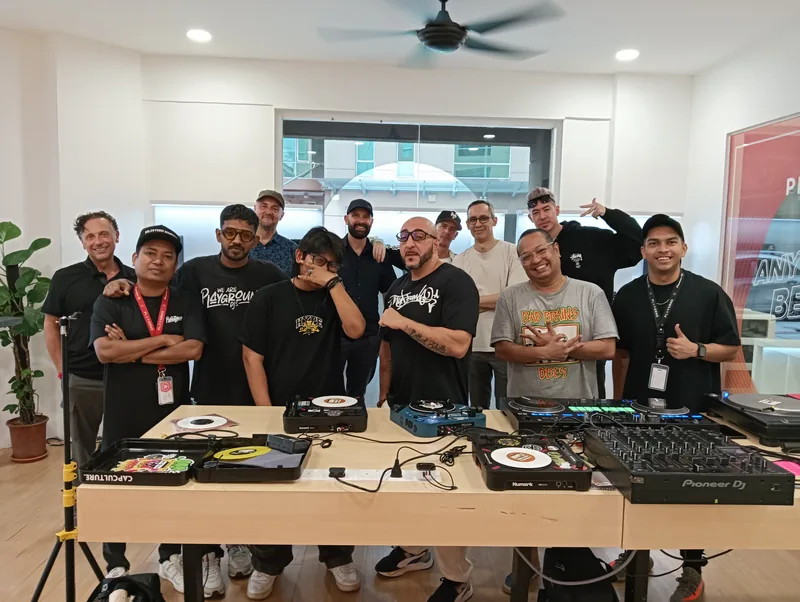 A skratch community session, people gathered around the decks